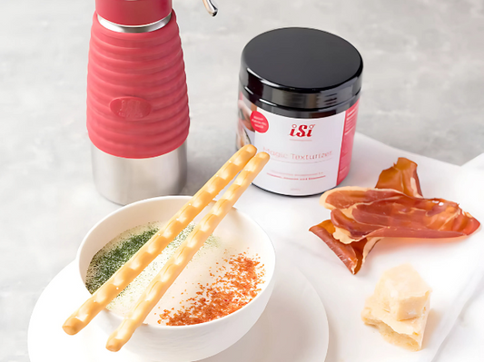 Herzhafter Dip mit Gewürzen und Grissini, serviert mit Parmaschinken und Parmesan – zubereitet mit iSi-Zutaten und dem iSi Gourmet Whip.